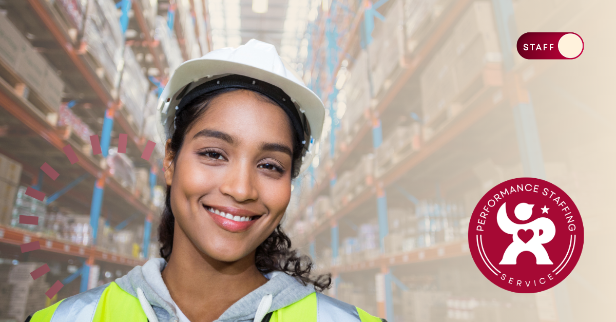 A woman wearing a hard hat and safety vest.